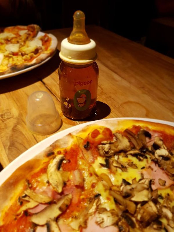 This restaurant has made a mixture of pizza in a small feeder with a pizza.